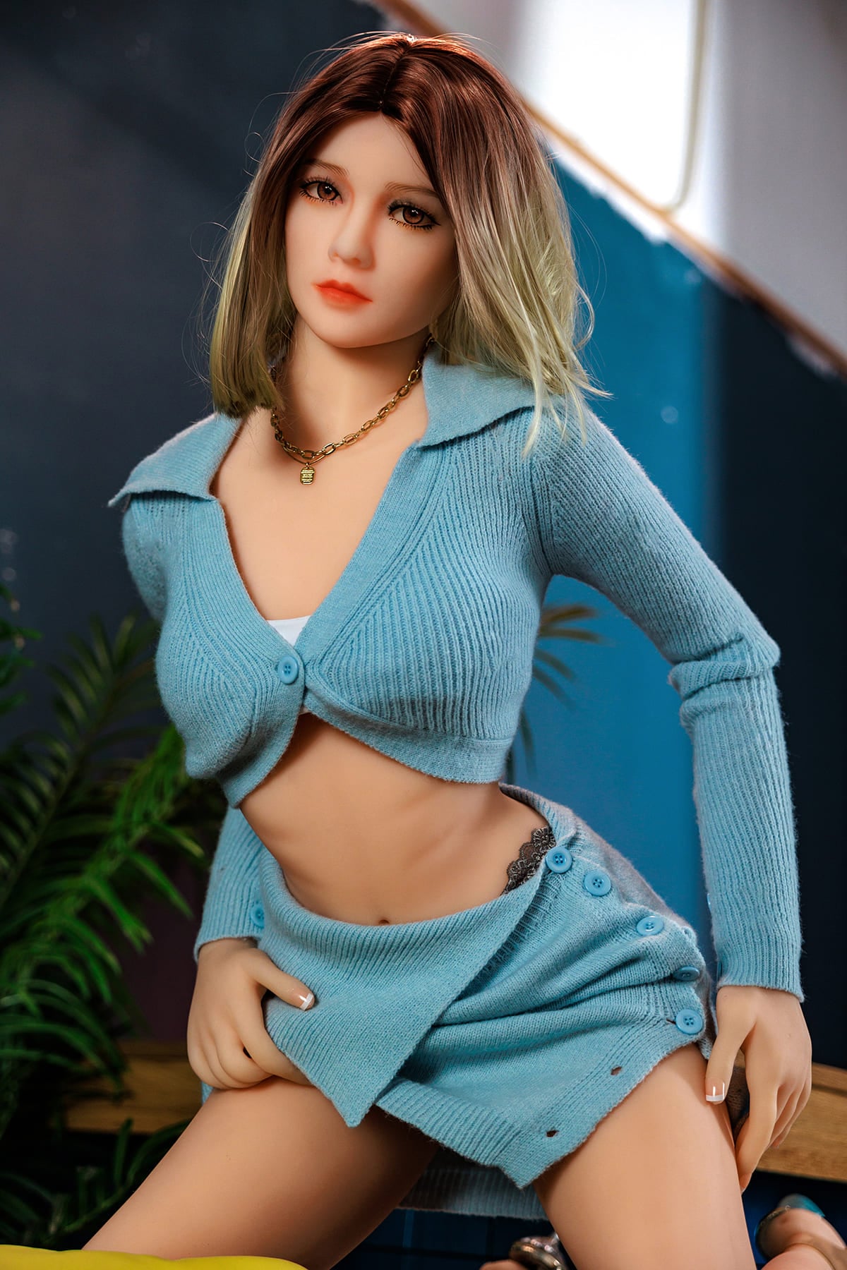 Asian female sex doll in blue sweater