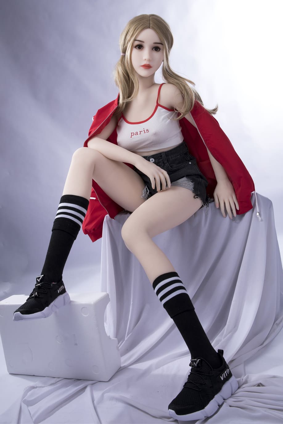 Slim young female sex doll in red coat