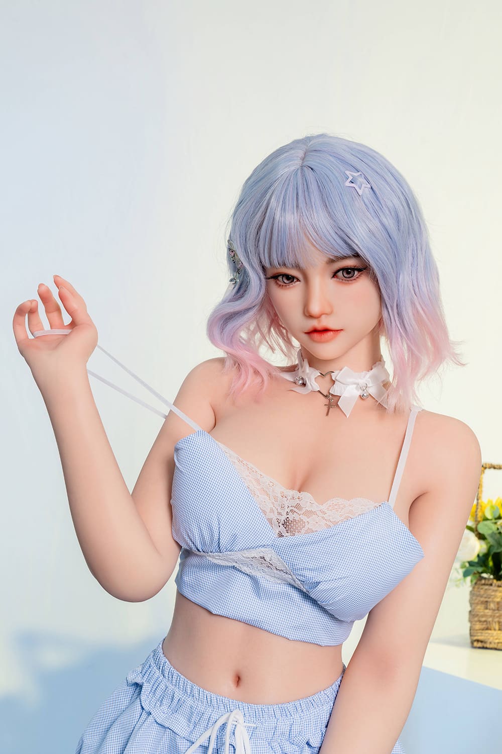 Cute blue haired young lifelike sex doll in a blue bra